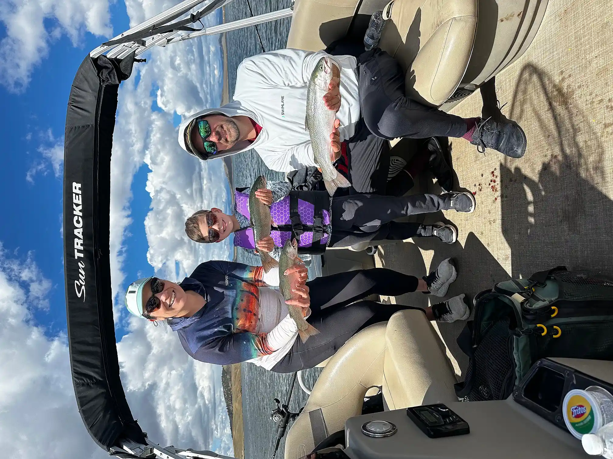 A family of three with their catch aboard the pontoon